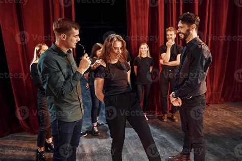 Eye contact practice. Group of actors in dark colored clothes on ...