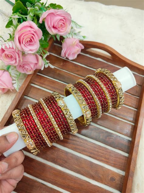 Simple and elegant golden triangle model mixed with Red glass bangles ...