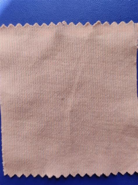 a knitted fabric which burns with a plastic burning smell and black ...