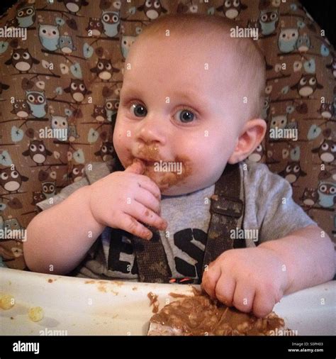 Baby eating peanut butter Stock Photo - Alamy