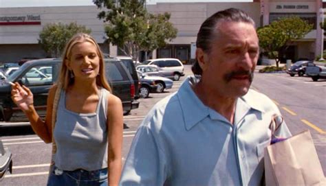 a man and woman walking down the street with shopping bags in their ...