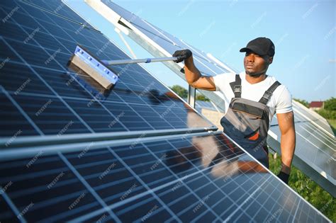Premium Photo | African american worker cleaning solar panel in solar ...