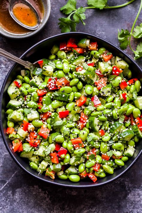 This simple Asian Edamame Salad packs a punch of flavor! Shelled edamame, cucumbers, red bell ...
