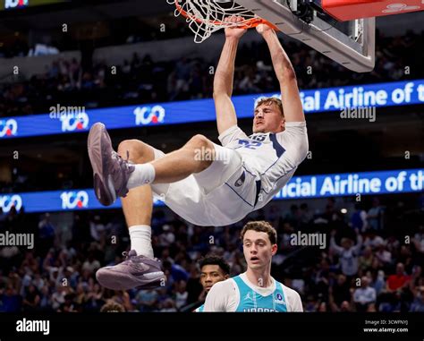 Dallas Mavericks forward Cooper Flagg, center, dunks during the first ...