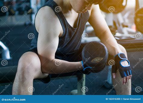 Fitness Man Doing Biceps Curl. Exercise with Sitting Dumbbell Curl at ...