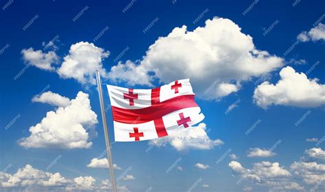 Premium Photo | Georgia flag waving in the beautiful sky