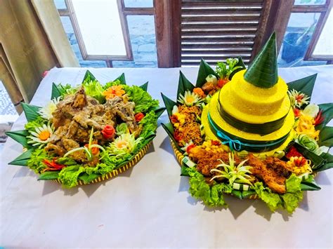 Side view yellow rice tumpeng indonesian traditional food with fried ...