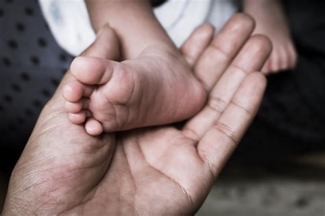 Closeup of food newborn in hand of mother,vintage | Premium Photo