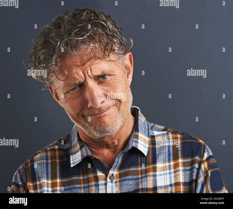 A bit befuddled. A cropped portrait of a confused-looking mature man ...