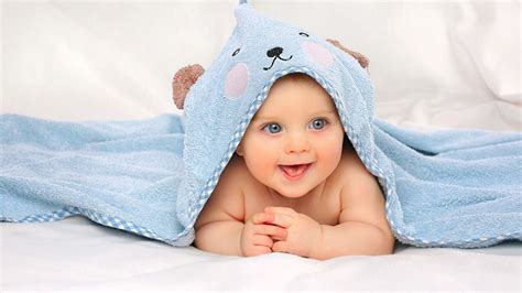 Smiling Grey Eyes Cute Child Baby Is Lying Down On White Cloth Covered ...