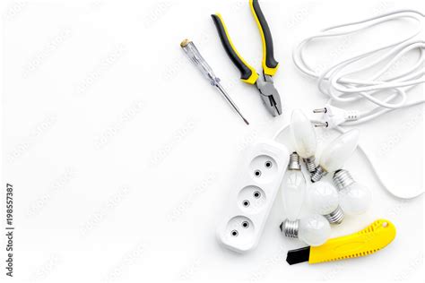 Electrical installation, wiring works. Tools and socket outlet on white background top view copy ...