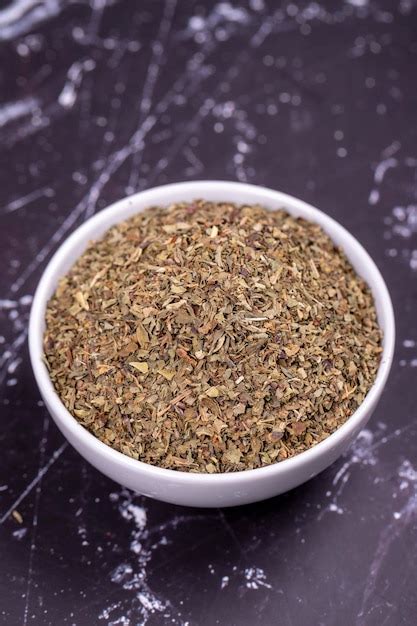 Dried crushed basil on dark background dried ground basil powder spices ...
