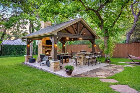 This freestanding covered patio with an outdoor kitchen and fireplace ...