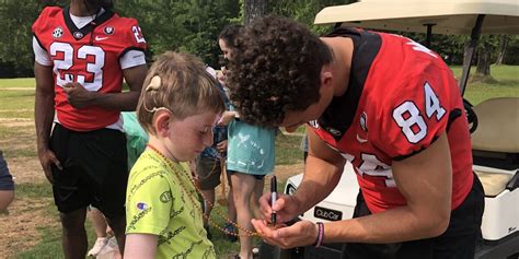 UGA football players surprise kids at Camp Rainbow