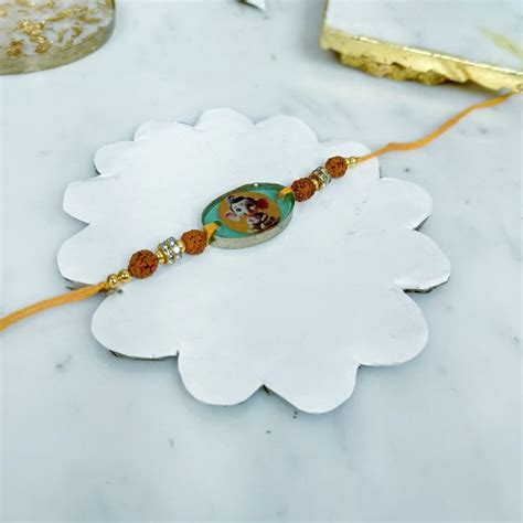 Send Divine Resin Ganesha Photo Rakhi Online