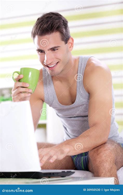 Young Men in Pajama Using Laptop Stock Photo - Image of bedroom ...