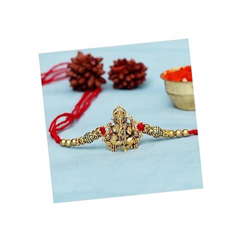 Buy eCraftIndia Golden Religious Designer Ganesha Rakhi with Red Thread ...