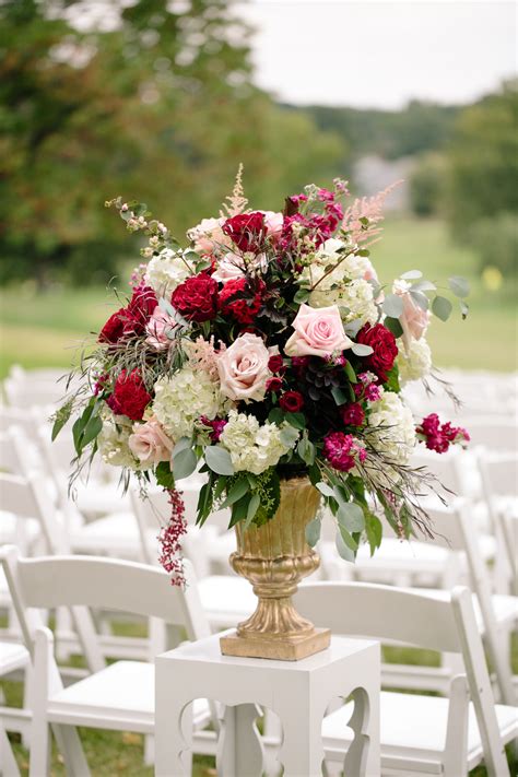 Gold Pedestal Ceremony Arrangement With Pink Roses and Red Ranunculus ...