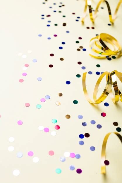 Colorful confetti and golden ribbons | Free Photo