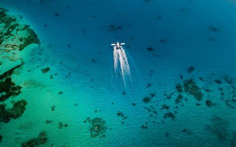 Download wallpaper 1280x800 plane, trail, sea, water, aerial view ...