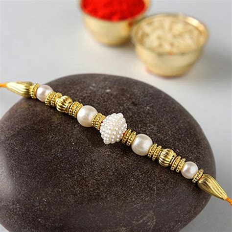 Send Divine Golden Pearl Thread Rakhi With Kaju Katli Box Online