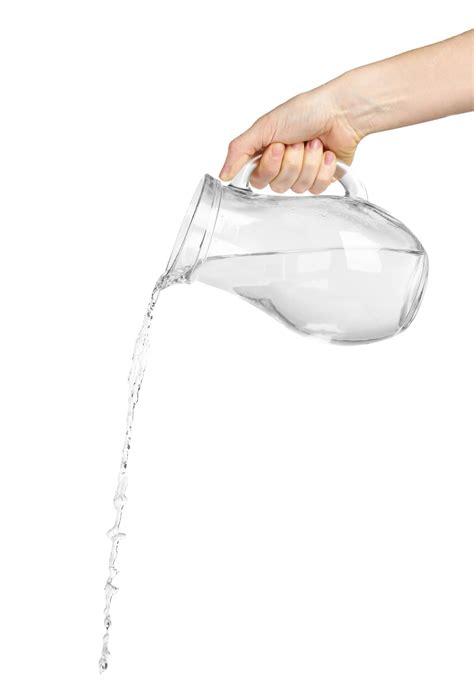 Premium Photo | Pouring water from glass pitcher isolated on white