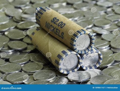 Stack of Nickel Rolls on a Pile of Scattered Coins Stock Image - Image ...