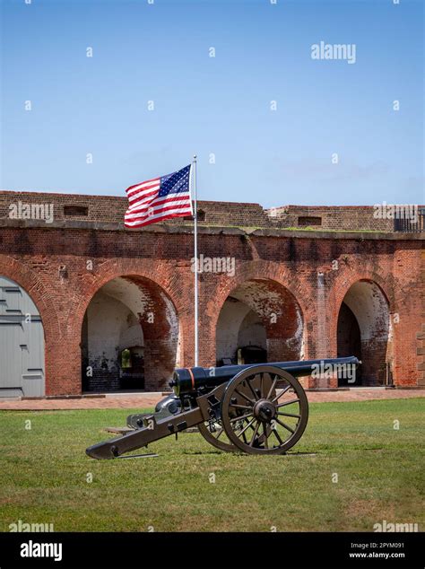 American flag behind a canon at Fort Pulaski in Savannah, GA, green ...