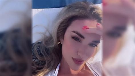 World's sexiest volleyball star Kayla Simmons almost pops out of her bikini as she relaxes on ...