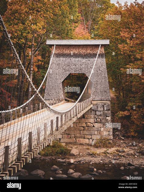 Autumn color and the wire bridge in New Portland, Maine Stock Photo - Alamy