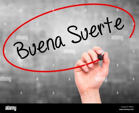 Man Hand writing Buena Suerte( Good Luck in Spanish) with black marker ...