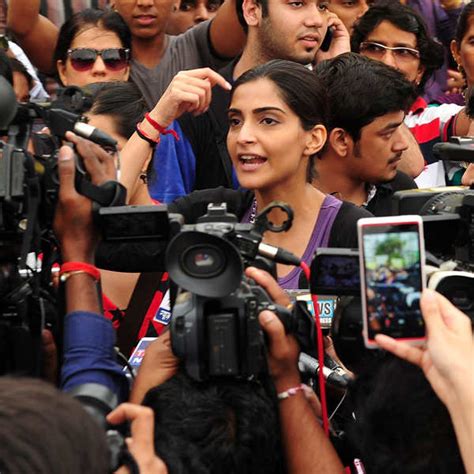 Indian activists hold posters during a protest march against the gang ...