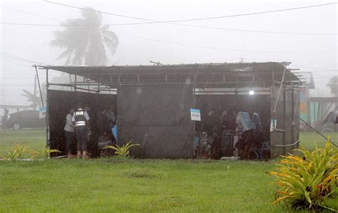 CAMEROON: A street vendor walks past a bar called "Facebook" in Yaounde ...