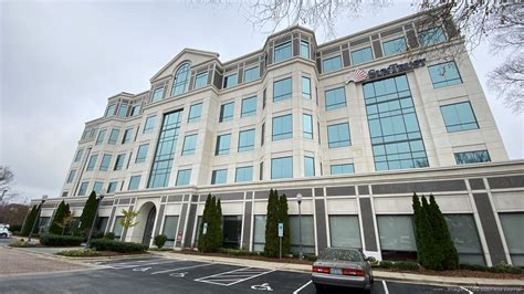 Modern office building with large windows, featuring the logo of a managed IT services provider, surrounded by landscaped greenery, representing business solutions in Pennsylvania.