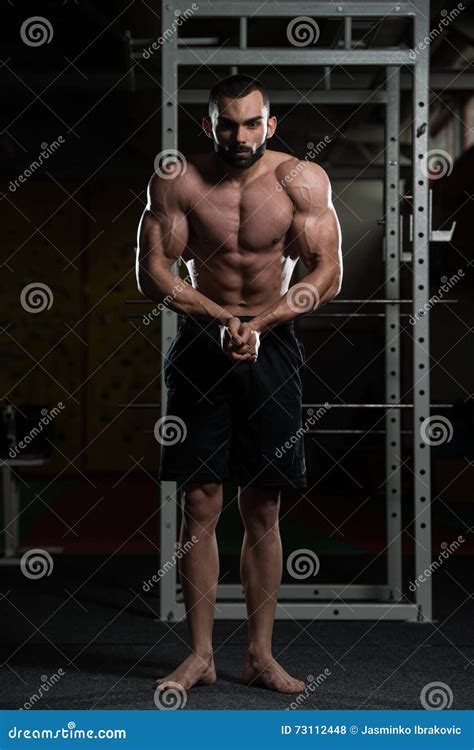 Handsome Body Builder Making Most Muscular Pose Stock Photo - Image of ...