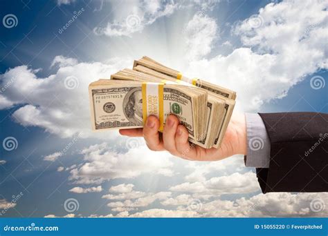 Male Hand Holding Stack of Cash Over Sky Stock Photo - Image of clouds ...