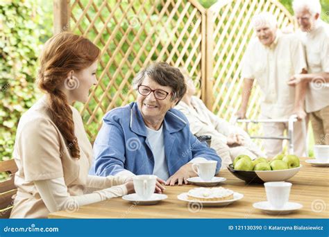 Snack Time with the Elderly on the Patio of a Nursing Home. Volunteer ...