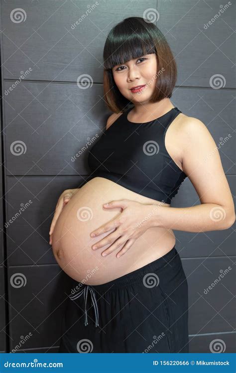 Pregnant Asian Woman Touching Her Big Belly Happily Stock Photo - Image ...