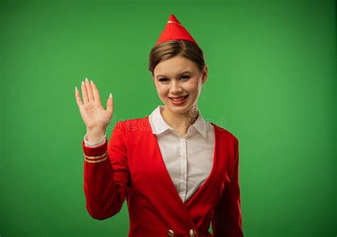 Young Smiling Woman Stewardess in Red Uniform Waving Hello Stock Photo ...