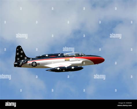 T-33 Shooting Star jet airplane flying high with USA flag colors. These ...