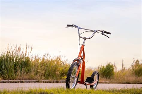 Kick scooter standing on the edge of an asphalt road | Premium Photo