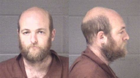 Police: Man falls off retaining wall, fires gun at passerby trying to ...