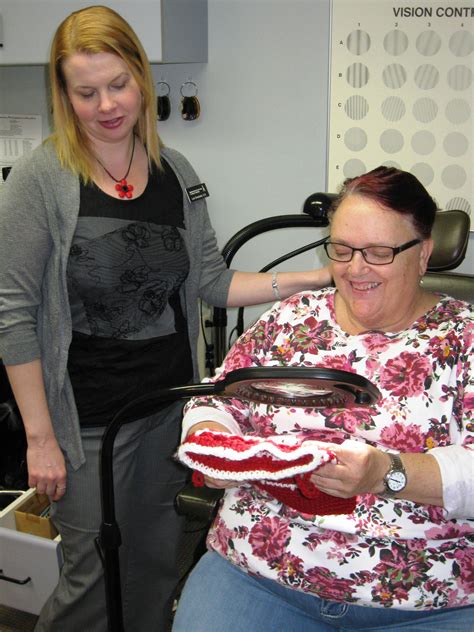 Low Vision Doctor with Client in chair with floor light magnifier | ABVI