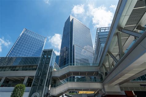 Looking up blue modern office building | Premium Photo