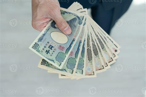 Japanese Yen money. close up of the Japanese yen on hand. currency of Japan that is used to ...