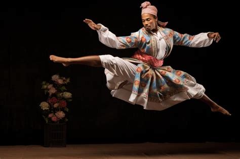 A martial artist in traditional attire performing a high kick | Premium ...