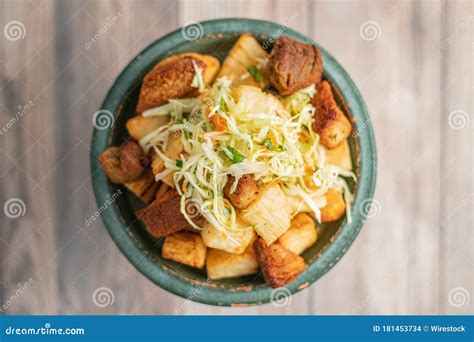 Bowl of a Delicious Traditional Yuca Con Chicharron Street Food on a ...