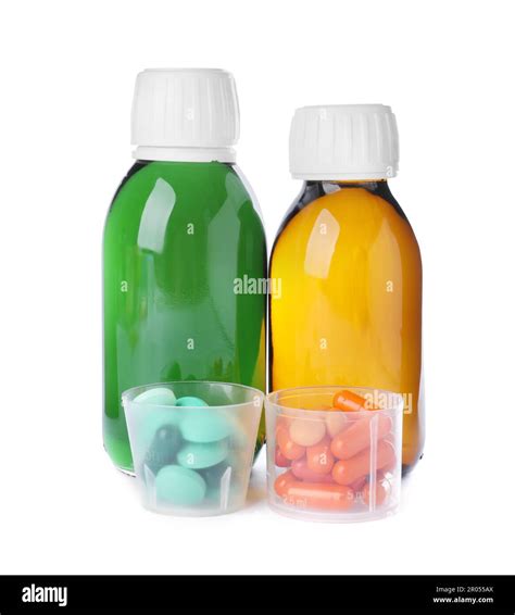 Bottles of syrups with pills on white background. Cough and cold ...