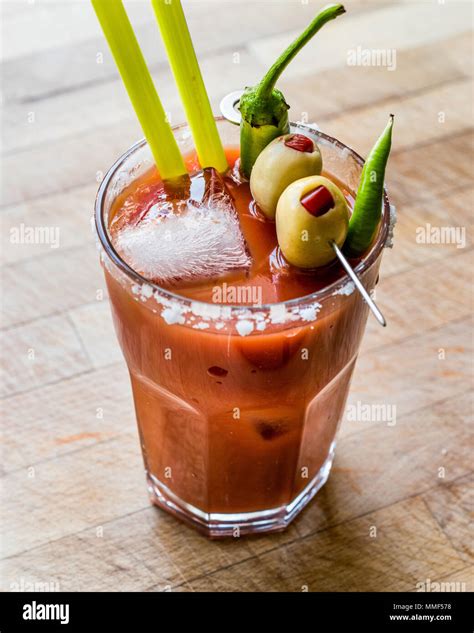 Bloody Mary Cocktail with green olive, pepper, salt and ice. Beverage ...