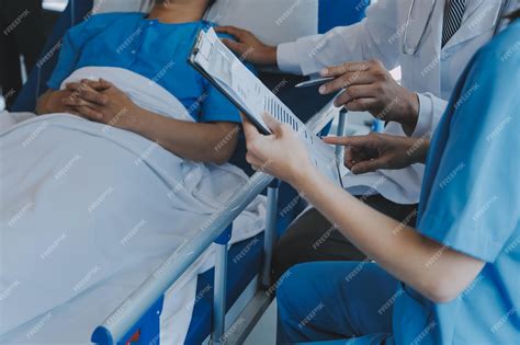 Injured patient showing doctor broken wrist and arm with bandage in ...